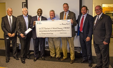 Duke Energy executives present SCDNR officials with a check for $984,800, January 19, 2017 in Columbia. From left to right: Duke Energy Director of Environmental Policy and Affairs, Mike Ruhe, Duke VP for Water Strategy and Hydro Relicensing Steve Jester, Duke State President for S.C. Kodwo Ghartey-Tagoe, Duke Senior Project Manager Mark Oakley, SCDNR Director Alvin Taylor, S.C. Natural Resources Board Chairman Cary L. Chastain and SCDNR Director of Environmental Programs Bob Perry. [SCDNR photo by D. Lucas]