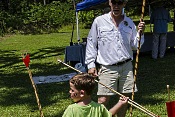 SCDNR archaeologist Sean Taylor shows this young man the finer points of throwing an atlatl, a primitive hunting weapon used with great skill by Native American hunters in prehistoric South Carolina.