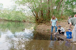 Teacher Holding a Bag of Trout Eggs