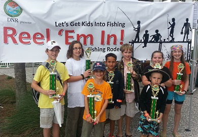 Winners from last year's Reel 'Em In fishing tournament show off their hardware. This year's tournament is set for Oct. 29 at the Mount Pleasant Pier in Charleston. (SCDNR photo)