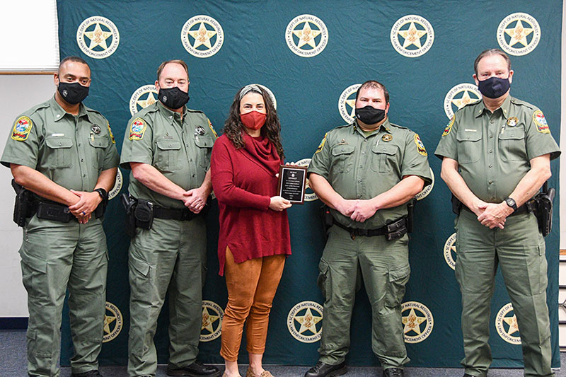 SCDNR leaders met with Kassy Alia Ray, founder of the "Serve and Connect" nonprofit on Feb. 4, 2021 in Columbia. Ray presented SCDNR Fsgt. Andrew Godowns with the organization's award for "excellence in community service" in 2020. From left to right are: SCDNR Lt. Col. Jamie Landrum, Col. Chisolm Frampton, Ms. Ray, FSgt. Godowns, and Maj. Gary Sullivan. [SCDNR photo by Danielle Kent]
