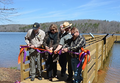 Cutting the ribbon at the new fishing pier at Croft State Park�s Lake Craig were (from left) Ross Self of SCDNR, Amanda Dow and Linda Hannon of Duke Energy, Phil Gaines and John Moon of S.C. State Parks, and James Horne of Friends of Croft State Park.