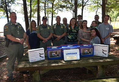 The family of the late Mitchell Don Gibson, a commercial fisherman who was lost on Lake Russell in March 2016, displays the three Lowrance digital side-scanning imaging units that were donated to South Carolina Department of Natural Resources (SCDNR) Region One Law Enforcement to help officers search for drowning victims.