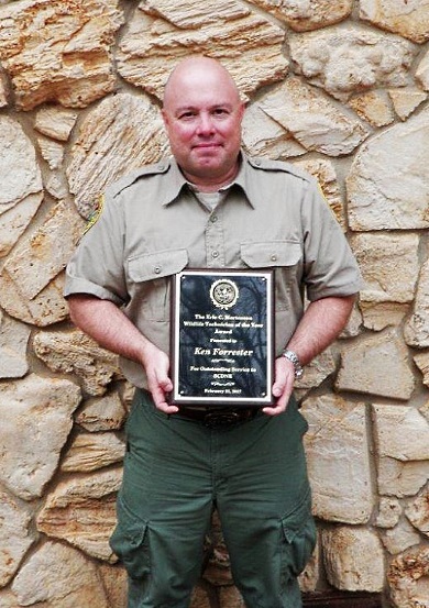 Ken Forrester, of Greer, who works for SCDNR in the Jocassee Gorges region, was a first responder during two natural disasters in 2016: Hurricane Matthew along the South Carolina coast and the Pinnacle Mountain Fire in northern Pickens County. He is shown holding the Eric Mortensen Memorial Wildlife Technician of the Year award. (SCDNR photo)