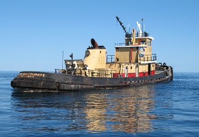 The Gen. Oglethorpe, a retired tugboat, rests on calm seas just before sinking. (Photo: Robert Martore/SCDNR)