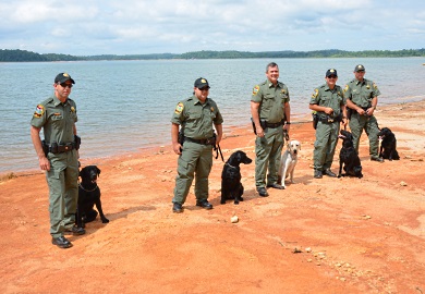 The SCDNR Canine Team, shown here beside Lake Hartwell in Pickens County, will be a key ingredient in SCDNR's law enforcement efforts. From left are Lance Cpl. Brian Welch of Clemson and 'Max'; Pfc. Patrick Nettles of Bamberg and 'Cash'; Capt. Gentry Thames of Pineland and 'Rio'; Pfc. Brian Urquhart of Florence and 'Lola'; and Sgt. Freddie Earhart of Moncks Corner and 'Blue.' (SCDNR photo by Greg Lucas)