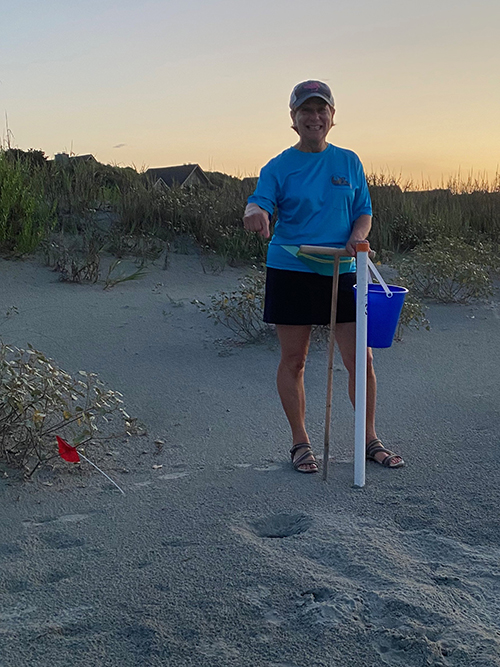 Kiawah Island Turtle Patrol member Barbara Pagnotta stands next to the state's first sea turtle nest to hatch in 2020. (Photo: Lynne Sager)
