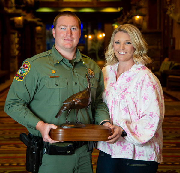 Dorchester County SCDNR Officer Tanner Riley is shown accepting the National Wild Turkey Federations "Wildlife Officer of the Year" award with his wife, Allison. (Photo courtesy NWTF)