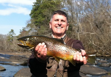 Local Angler Randy Ell displays a brown trout he caught near Saluda Shoals Park.