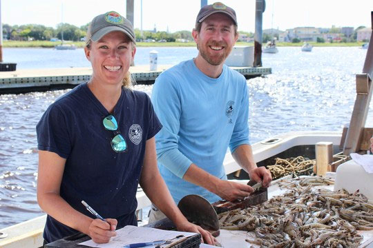 SCDNR biologists Kristin Hamilton and Mike Kendrick measure and count white shrimp aboard a regular trawl survey in 2018. (Photo: E. Weeks/SCDNR)