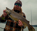 a guy holding a Brown trout