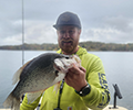 a man holding a Crappie