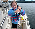 a girl holding a Brown trout