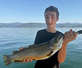 a boy holding a Brown Trout