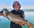 a boy holding a Brown trout
