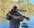 a man holding a Brown trout