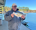 a man holding a Crappie