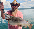a man holding a Brown trout