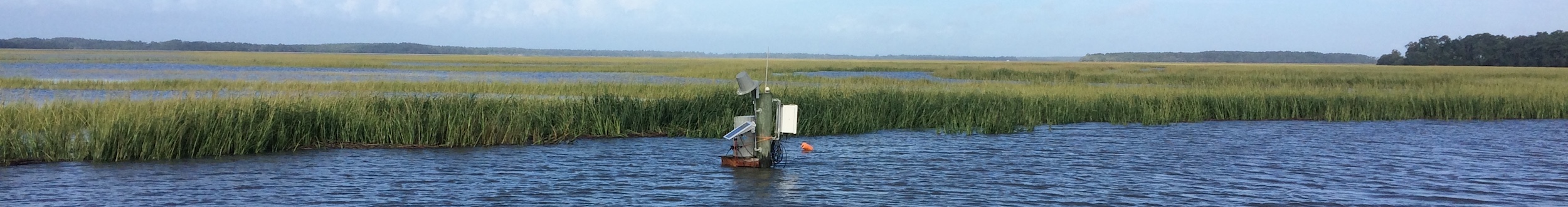 A water quality monitoring station sits just above the water