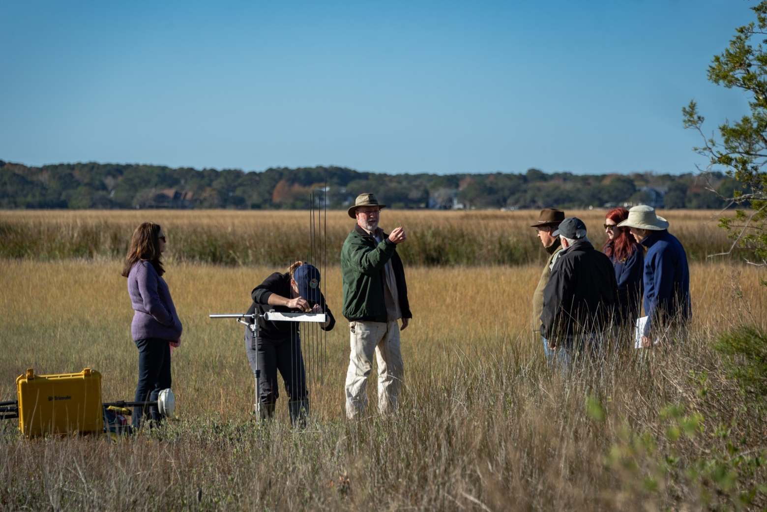 A SCDNR employee standing in a field training others